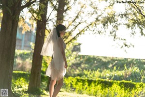 A close up of a woman's butt in a white dress.