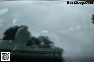 A woman sitting in the back of a car.