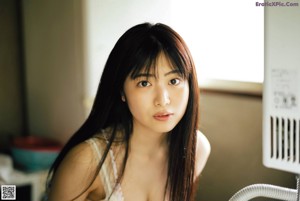 A woman laying on a tatami mat in a room.