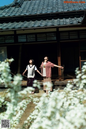 A couple of women standing next to each other in a river.