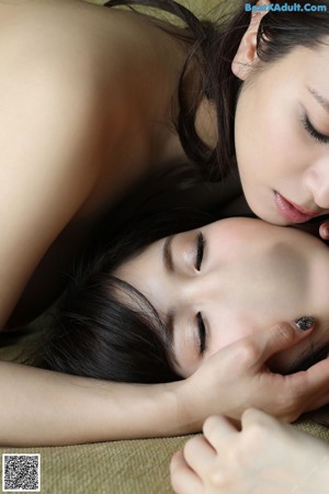 Two asian women in white lingerie posing for the camera.